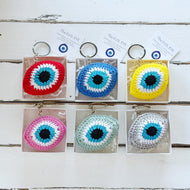 Set of colorful evil eye keychains in packaging in gift box